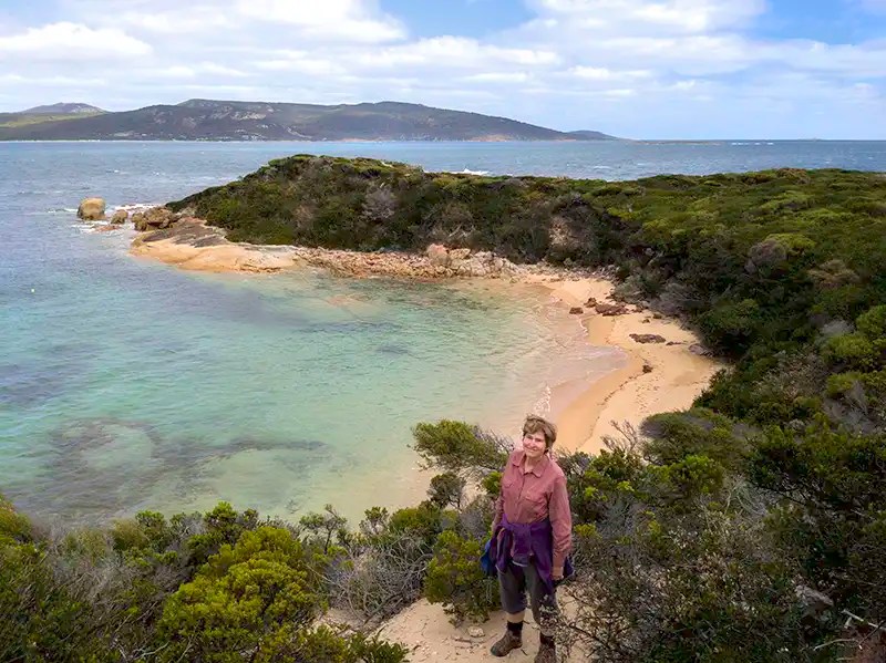 Christine is standing high above a small bay near Stackys Bight.
